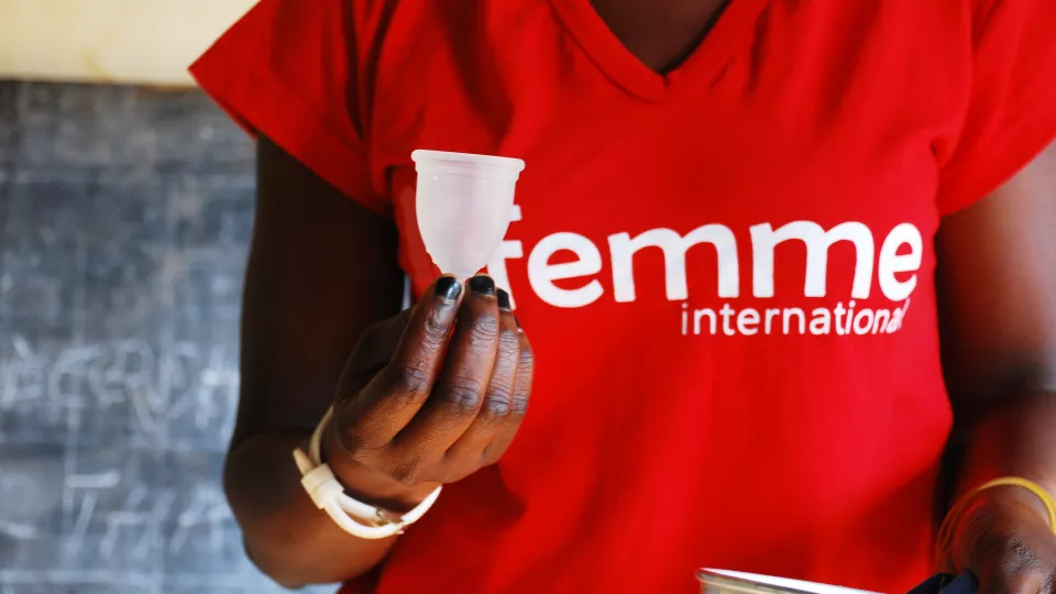 Women holding a menstrual cup. Photo