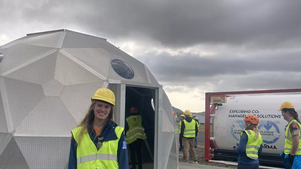 Woman standing in front of a CO2 injection-site on Iceland. Photo.