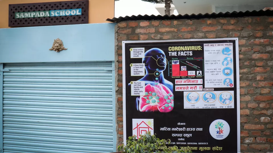A poster on a wall to raise awareness about the coronavirus outside of a closed school in Kathmandu. Photo: Hanna Geschewski