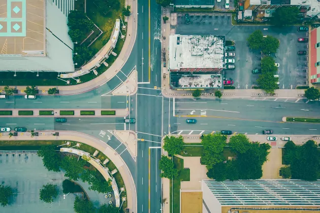 A crossroads seen from above with trees. Photo: Unsplash.