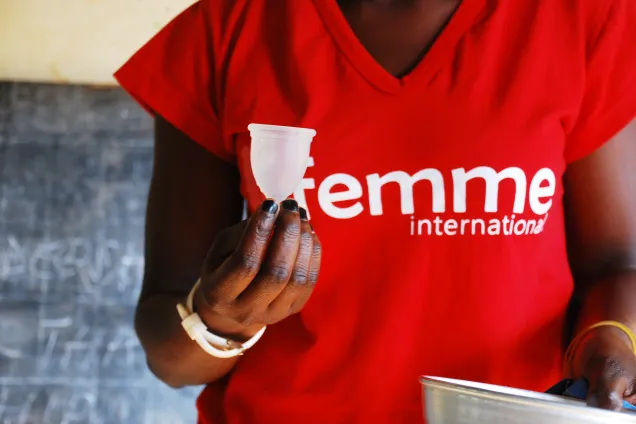 Women holding a menstrual cup. Photo