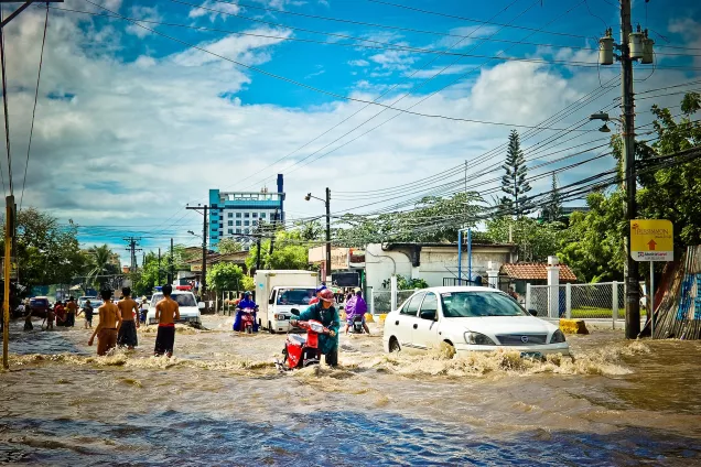 People on a flooded street in a city. Photo.
