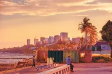 A man sitting by the water in Maputo, Mozambique. Photo Unsplash.
